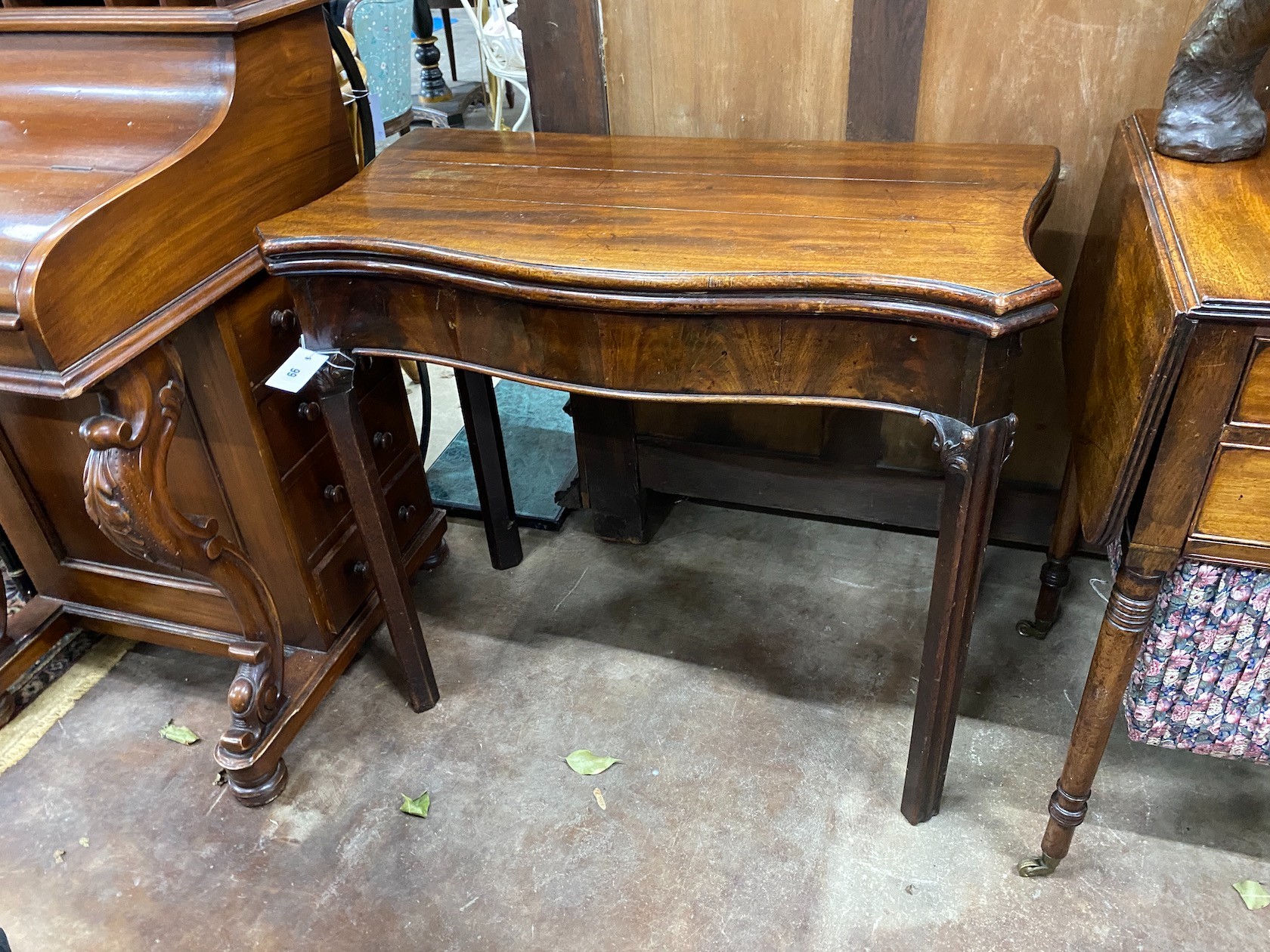 A George III serpentine mahogany foding card table, width 80cm, depth 40cm, height 73cm